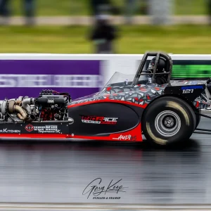 Ben racing hard in the Comp Eliminator, Festival of Power 2025, Santa Pod Raceway. Red & Black Bantam, speed blurred background