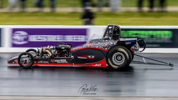 Ben racing hard in the Comp Eliminator, Festival of Power 2025, Santa Pod Raceway. Red & Black Bantam, speed blurred background