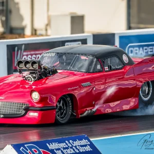 Kev Slyfield's red 1957 Ford Thunderbird bodied Pro Mod in burn out mode!