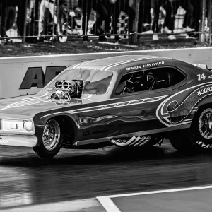 Simon Hayward's 'Houndog' Nostalgia Funny Car looking fierce & picking up the front wheels at Santa Pod Raceway